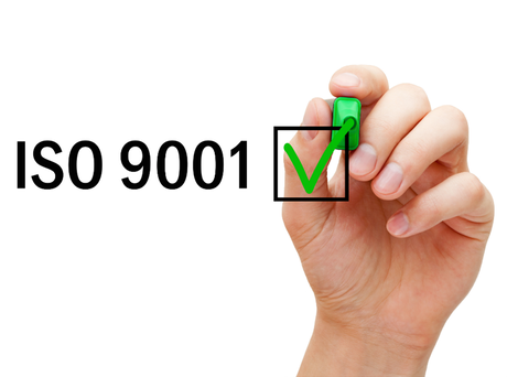A lady writing the words ISO 9001 with a green tick box for Grace Professional Services 